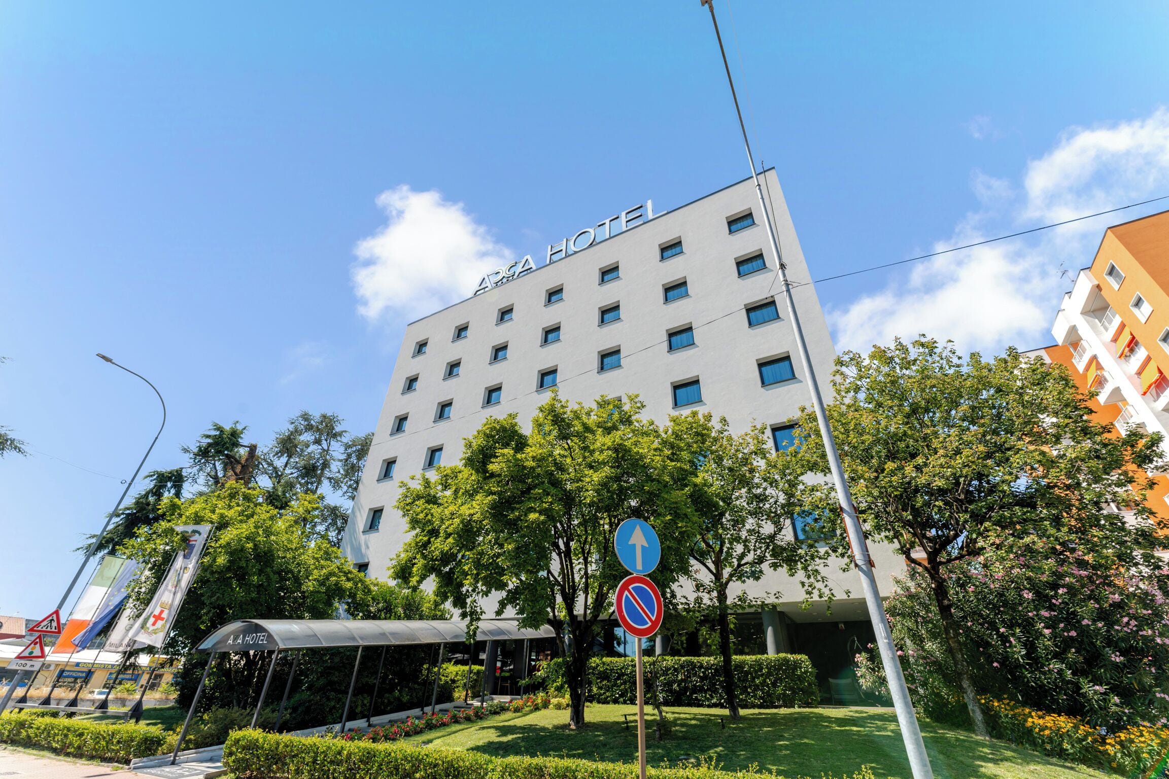 A hotel building with a sign reading 'A.A HOTEL' and a no parking sign.