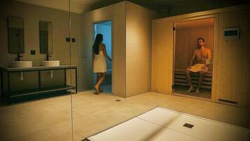 A modern bathroom with a large mirror, two sinks, and a wooden sauna.