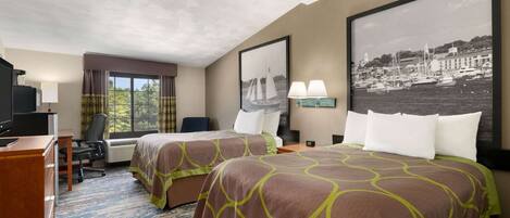 A hotel room with two beds, a desk, a chair, a TV, a window with curtains, and a framed picture on the wall.
