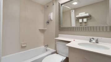 A modern bathroom with a bathtub, toilet, and sink.