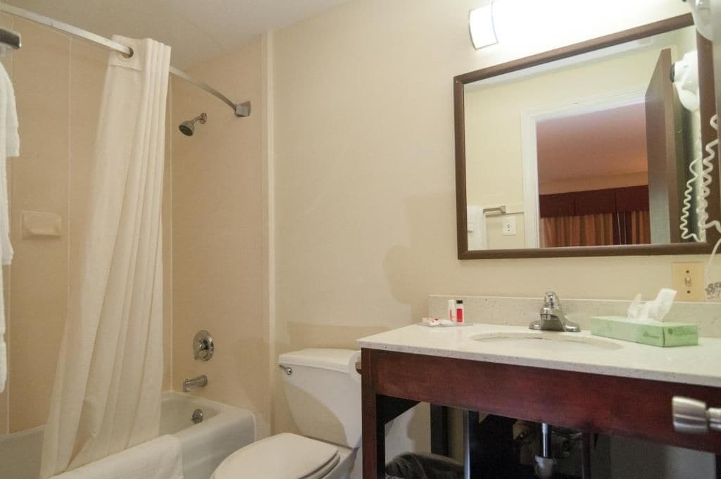 A bathroom with a bathtub, toilet, and sink.