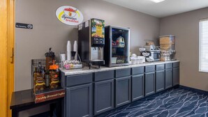 A breakfast bar with coffee machines, a refrigerator stocked with milk and juice, and a sign indicating no smoking. - Super 8 by Wyndham Jackson MN (Jackson)