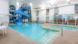An indoor swimming pool with a blue water slide and a separate pool area. - Super 8 by Wyndham Three Hills AB (Three Hills)