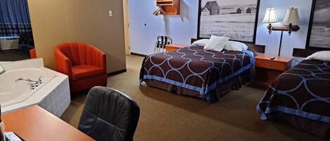 A hotel room with a bed, two bedside tables, a chair, a desk with a telephone, and a window.