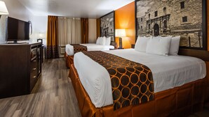 A hotel room with two beds, a TV, a desk, and a lamp. - SureStay Plus by Best Western San Antonio Airport (San Antonio)