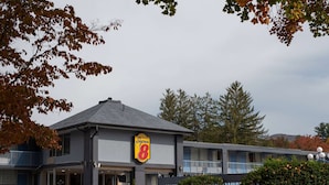 A motel with a prominent 'Super 8' sign, a two-story structure, and a covered parking area.