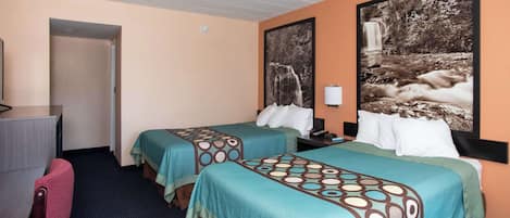 A hotel room with two beds, a desk, and a chair.