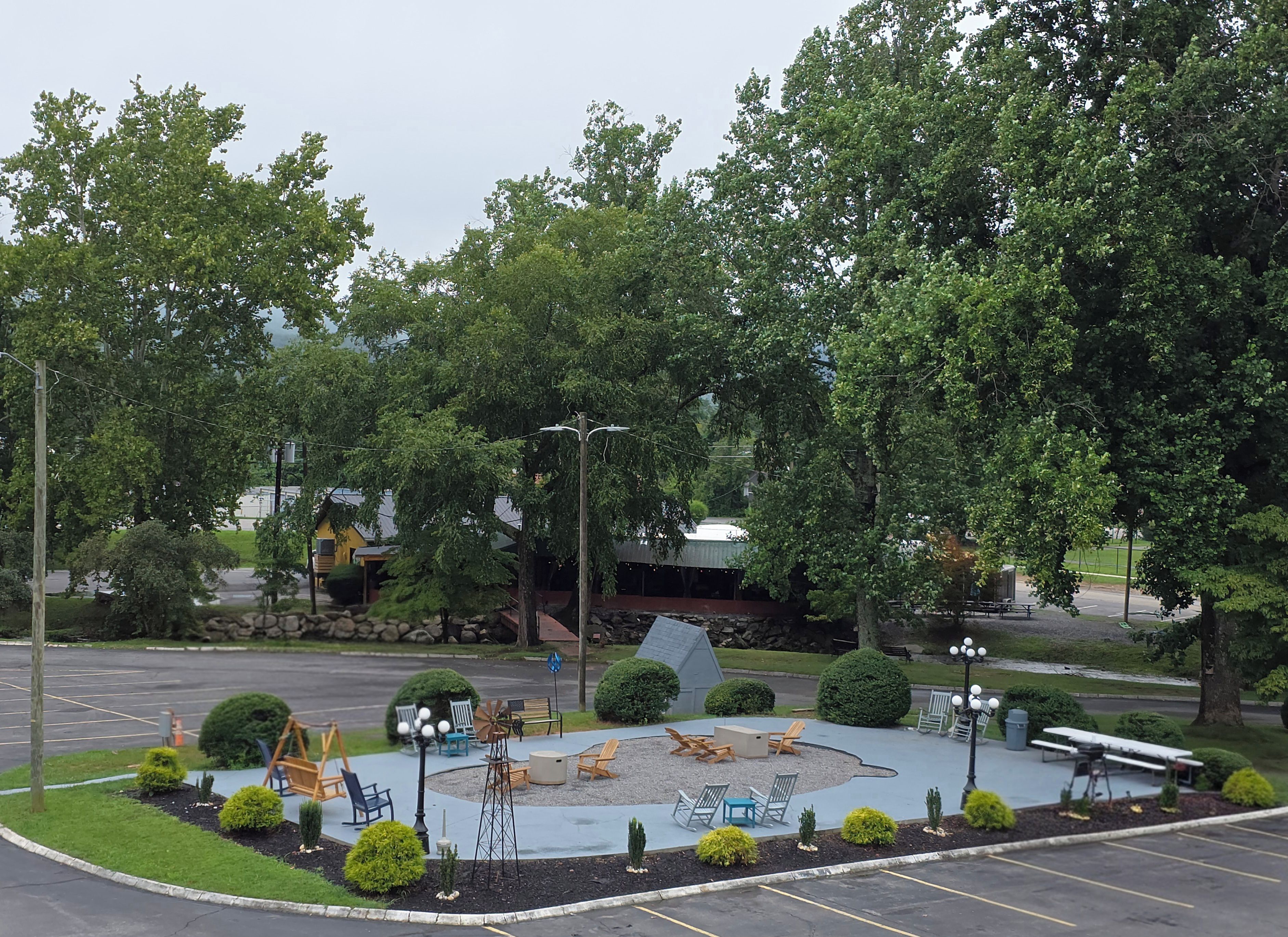 A park with a circular seating area, benches, and a playground.