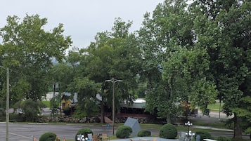A park with a circular seating area, benches, and a playground.