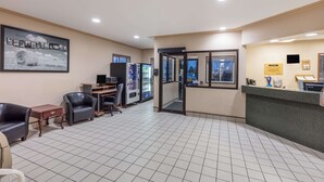 A reception area with a counter, seating, a refrigerator, and a framed welcome sign. - Super 8 by Wyndham Moose Jaw SK (Moose Jaw)