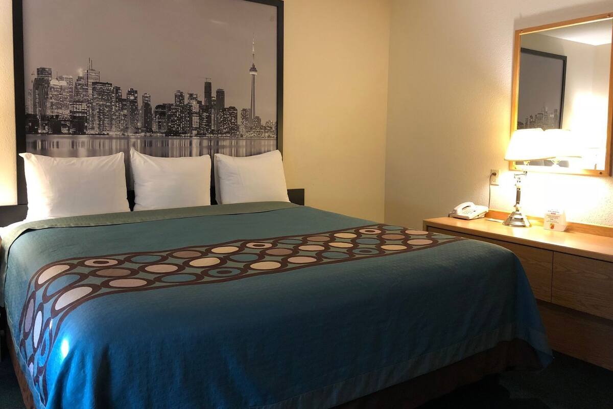 Desk, laptop workspace, blackout drapes, iron/ironing board