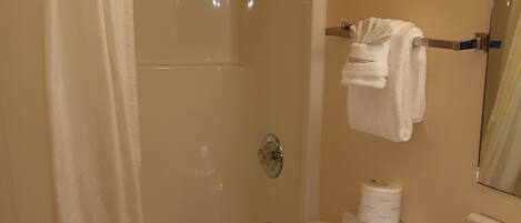 A bathroom with a bathtub, toilet, and sink.