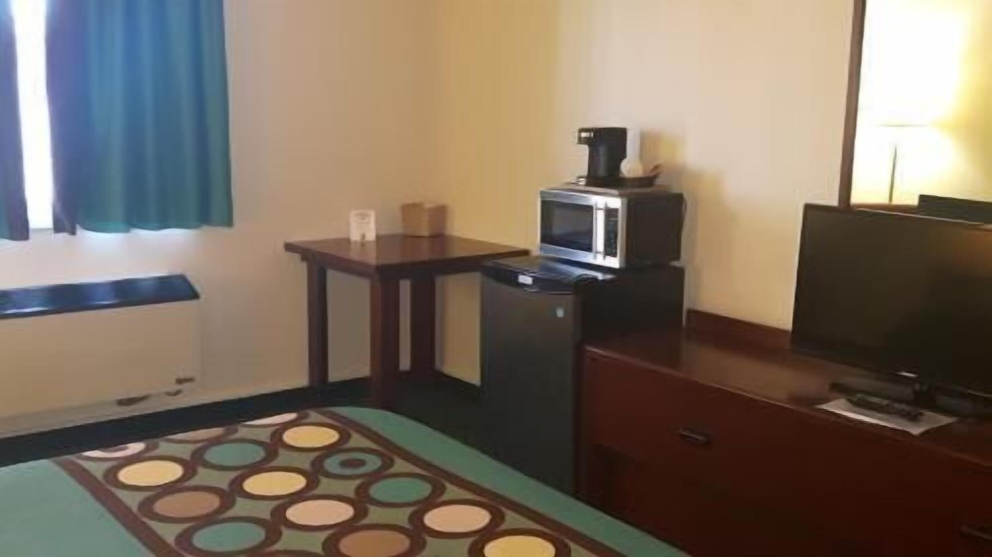 Desk, laptop workspace, blackout drapes, iron/ironing board