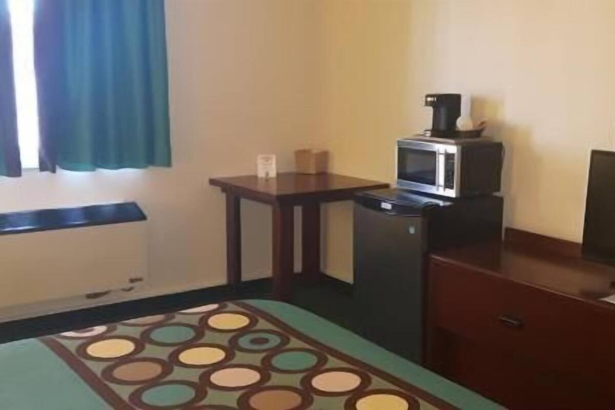 Desk, laptop workspace, blackout drapes, iron/ironing board