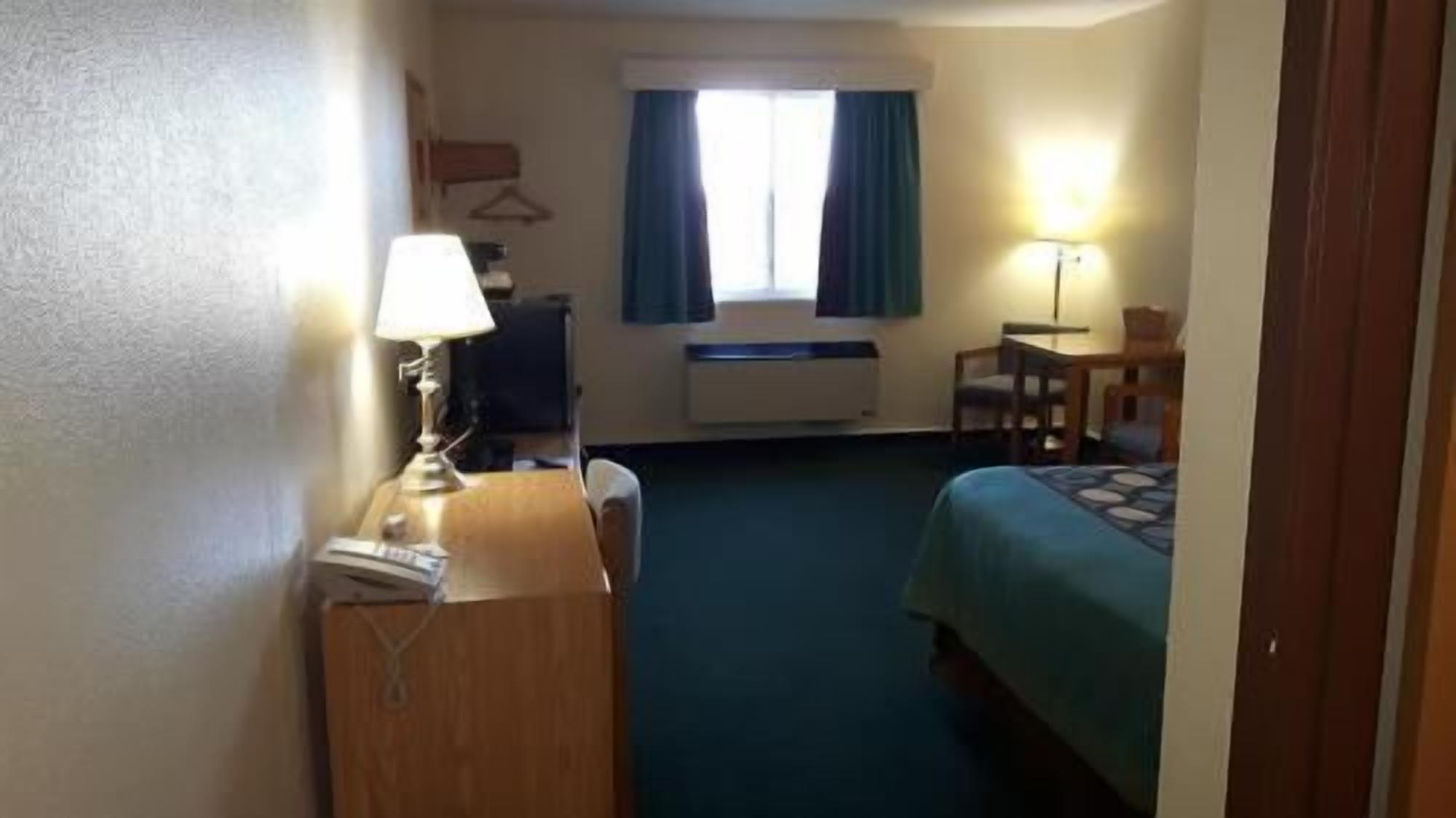 Desk, laptop workspace, blackout drapes, iron/ironing board