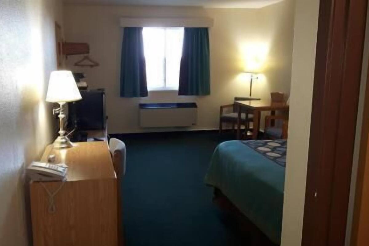 Desk, laptop workspace, blackout drapes, iron/ironing board