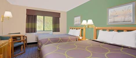 A hotel room with two beds, a desk, and a window with curtains.