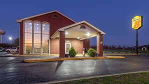 A Super 8 hotel with a brick facade, large windows, and a well-lit entrance. - Super 8 by Wyndham Nixa/Springfield Area (Nixa)