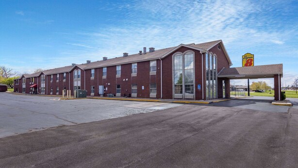 A large brick building with a covered entrance and a Super 8 sign. - Super 8 by Wyndham Nixa/Springfield Area (Nixa)