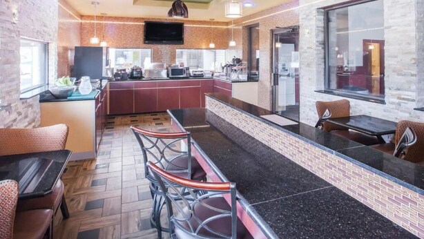 Een moderne keuken met een centraal eiland, een bar en een groot raam.