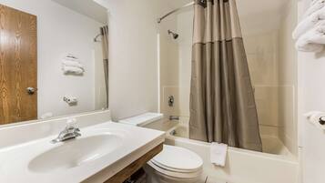 A bathroom with a sink, toilet, and bathtub.
