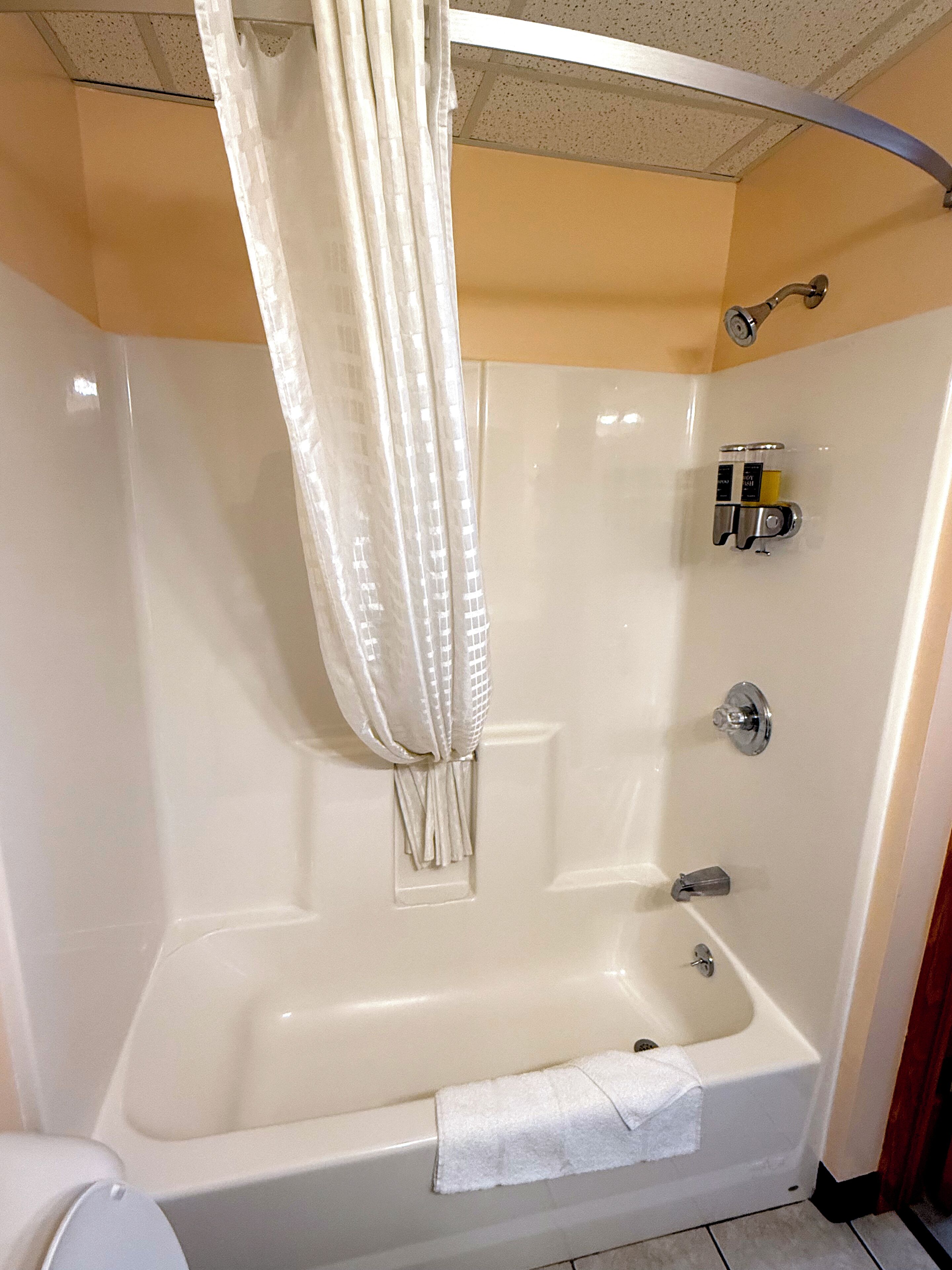 A bathroom with a bathtub, a shower, and a toilet.