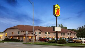 A Super 8 motel with a central entrance, multiple rooms, and a parking lot. - Super 8 by Wyndham Concordia (Concordia)