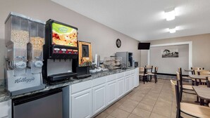 A self-service breakfast bar with a coffee machine, cereal dispensers, and a digital menu display. - Super 8 by Wyndham Pratt (Pratt)