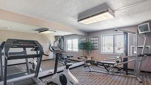 A gym with treadmills, elliptical machines, and a mirrored wall. - Motel 6 Marshalltown, IA (Marshalltown)