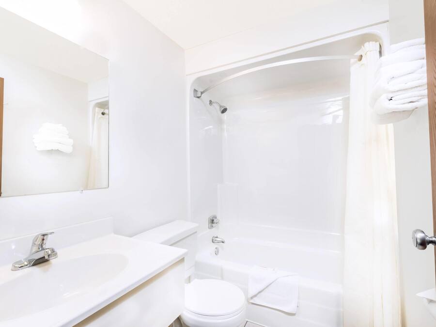 A bathroom with a sink, toilet, and bathtub.