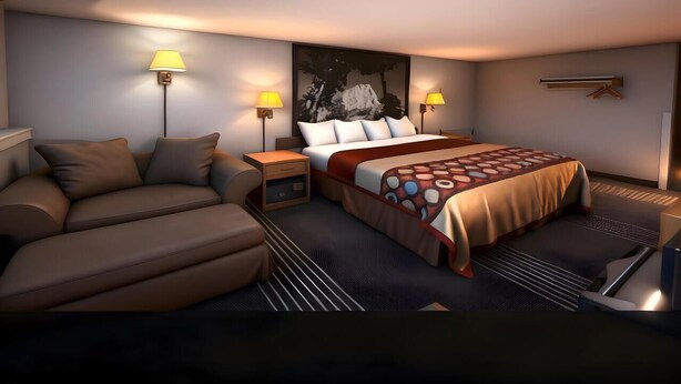 A modern hotel room with a sofa, a bed with a patterned bedspread, two bedside lamps, and a large abstract painting on the wall.