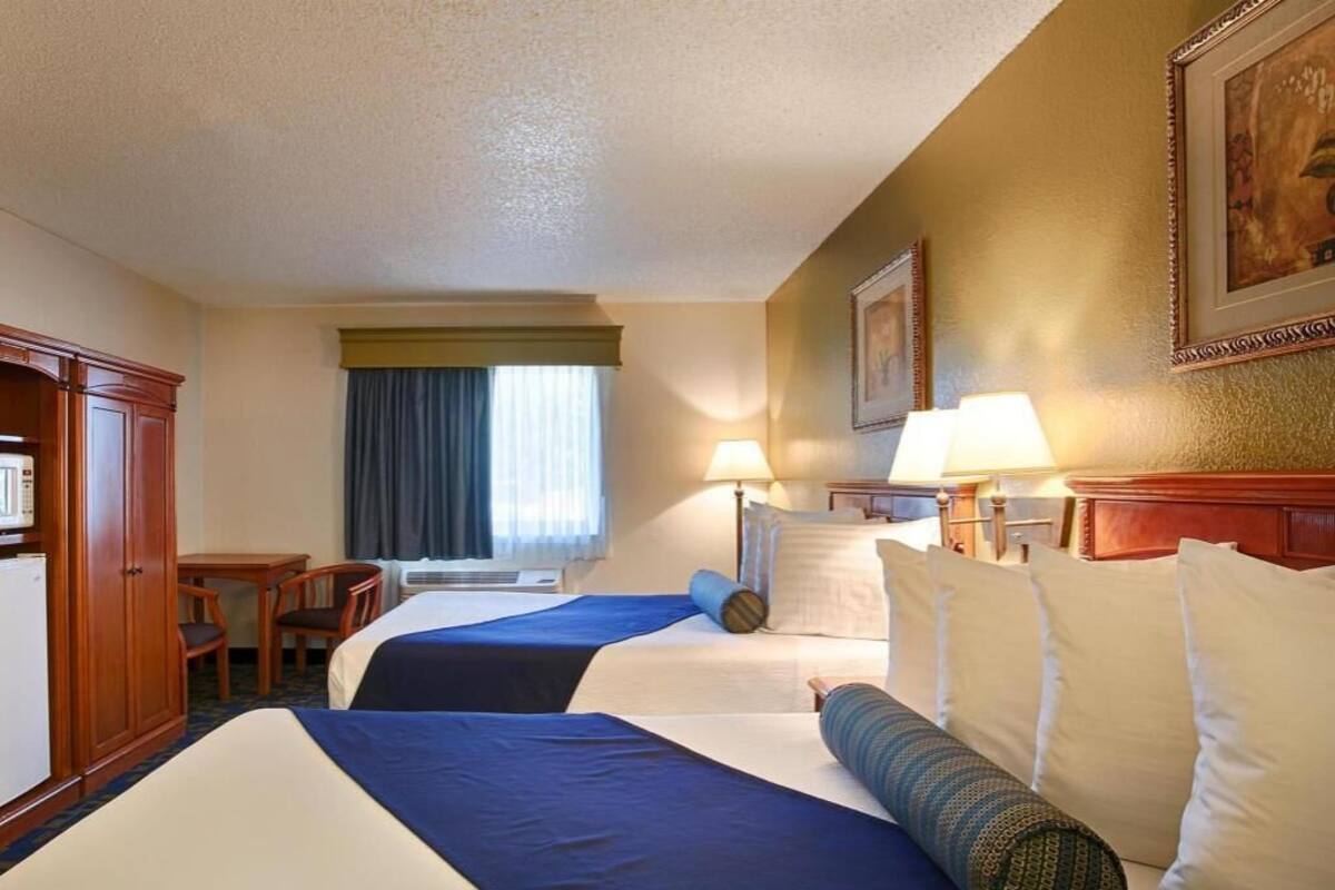 Desk, laptop workspace, iron/ironing board, free cribs/infant beds