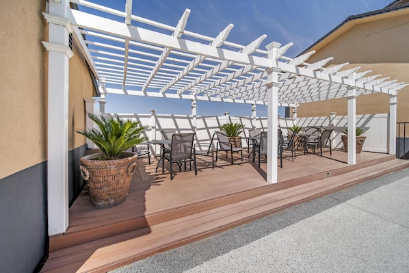 An outdoor patio with a pergola, seating area, and potted plants. - Best Western Antelope Inn & Suites (Red Bluff)