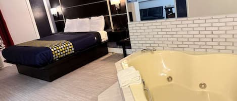1 King Suite Jacuzzi, Non Smoking | Hypo-allergenic bedding, in-room safe, laptop workspace, blackout drapes