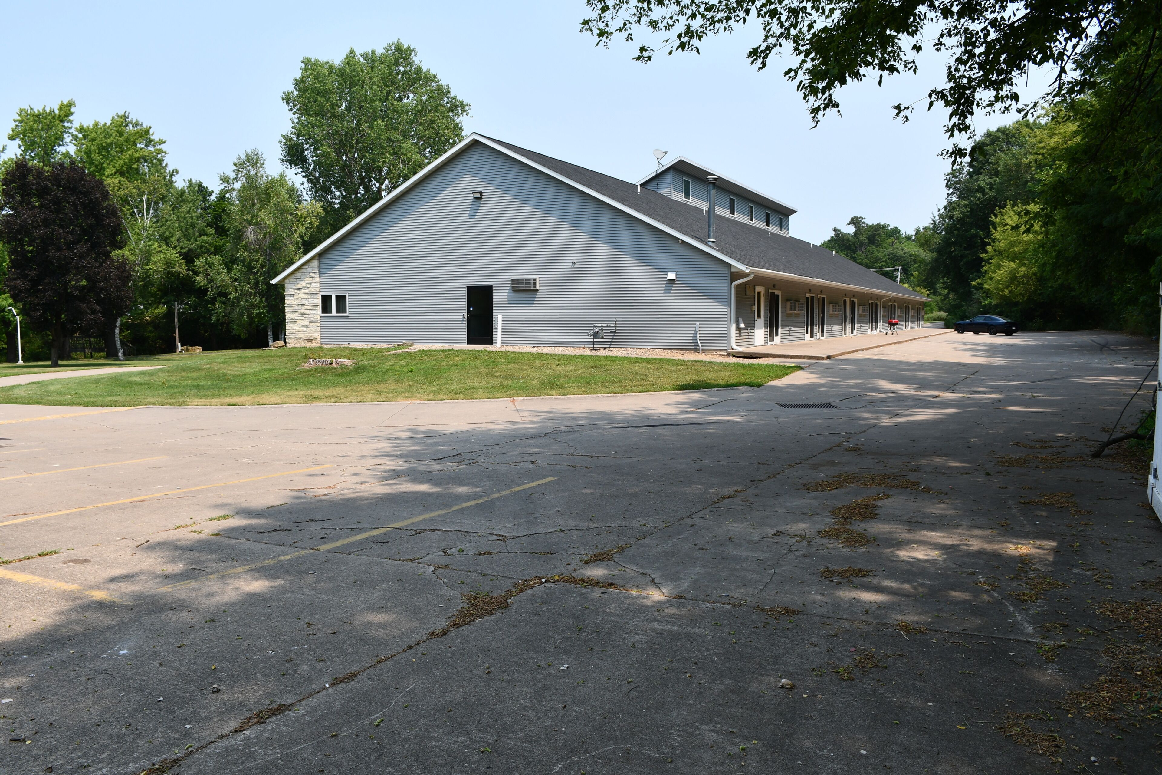 A large, single-story building with a flat roof and a covered porch area.