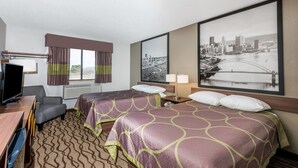 A hotel room with two beds, a desk, a TV, a window with curtains, and a cityscape picture on the wall. - Super 8 by Wyndham Bedford (Bedford)