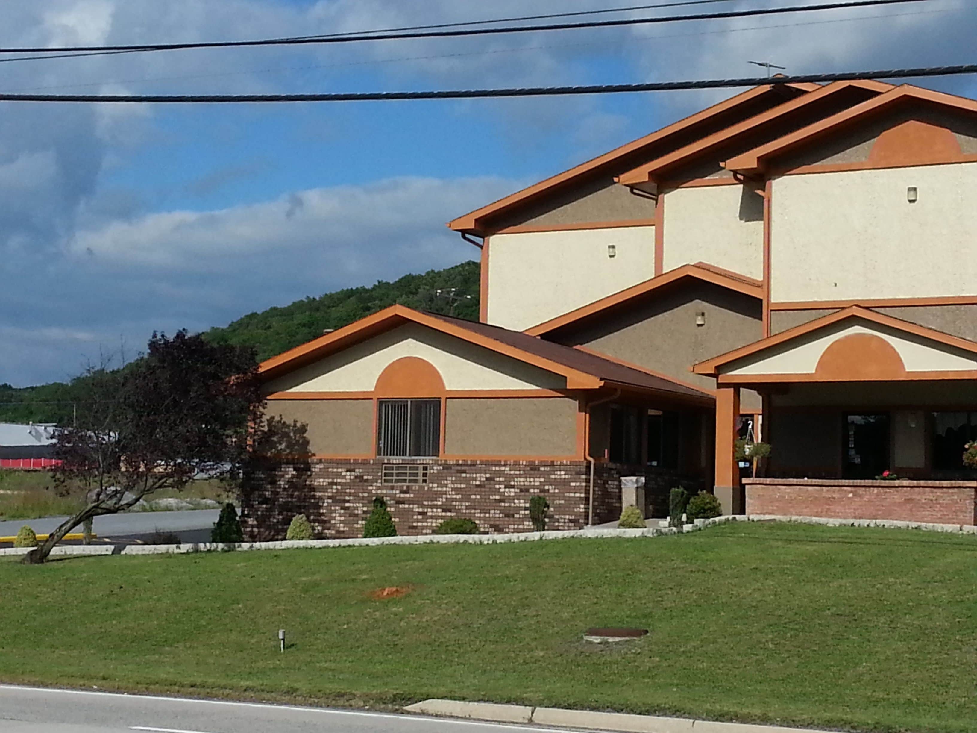 A two-story house with a brick facade and a flat roof.