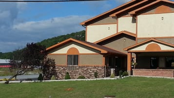 A two-story house with a brick facade and a flat roof.