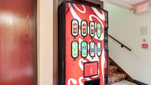 A vending machine with various drink options, an exit sign, and a fire alarm. - Red Roof Inn Franklin, KY (Franklin)