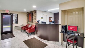 A reception area with a desk, computer, and a sign indicating free Wi-Fi and all rooms. - Red Roof Inn Franklin, KY (Franklin)