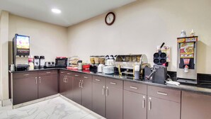 A kitchenette with a microwave, toaster, coffee maker, and a waffle maker. - Red Roof Inn Franklin, KY (Franklin)