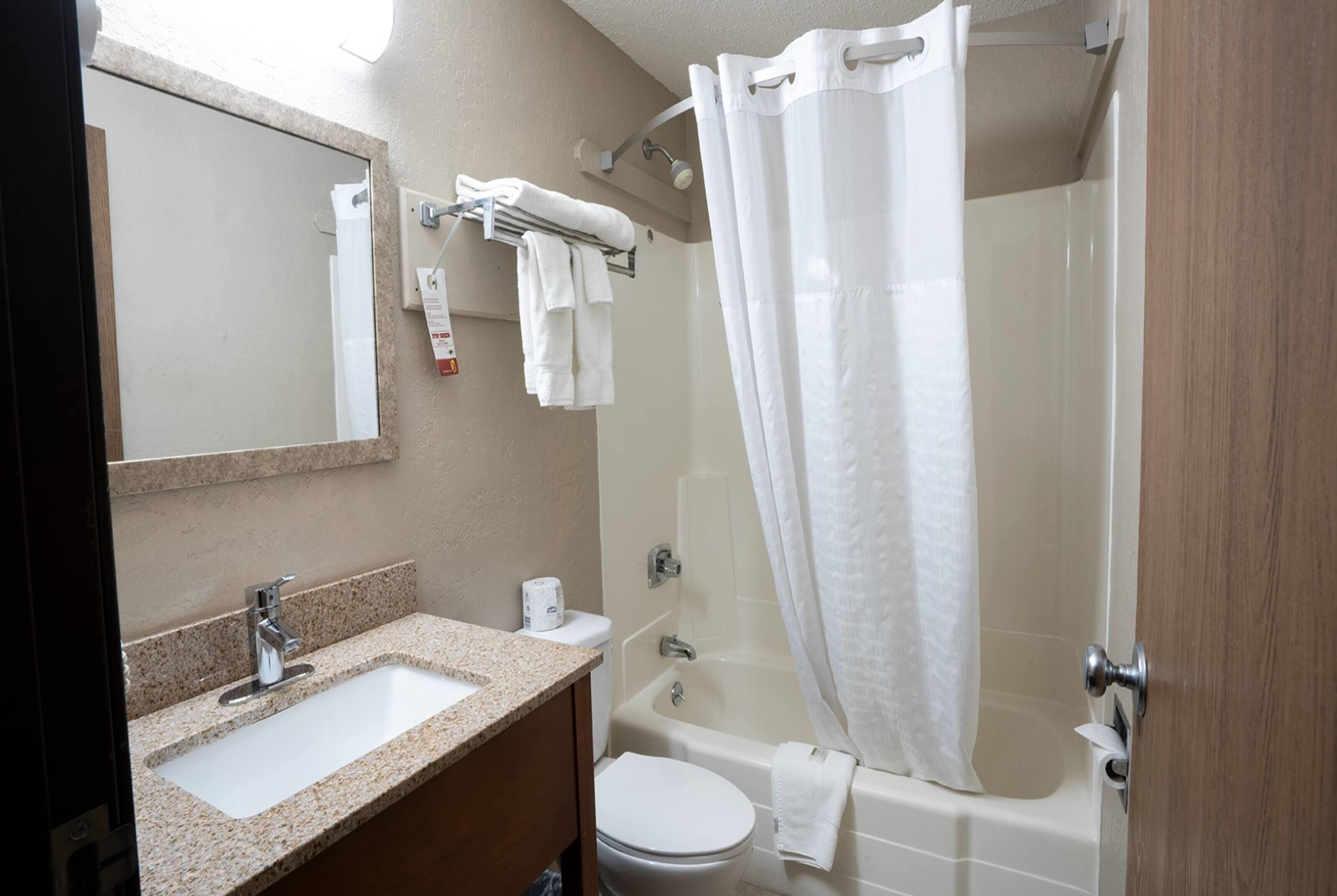 A bathroom with a sink, toilet, and bathtub.