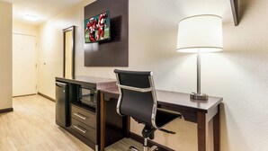 A hotel room with a desk, chair, TV, and a lamp. - Red Roof Inn Dry Ridge (Dry Ridge)