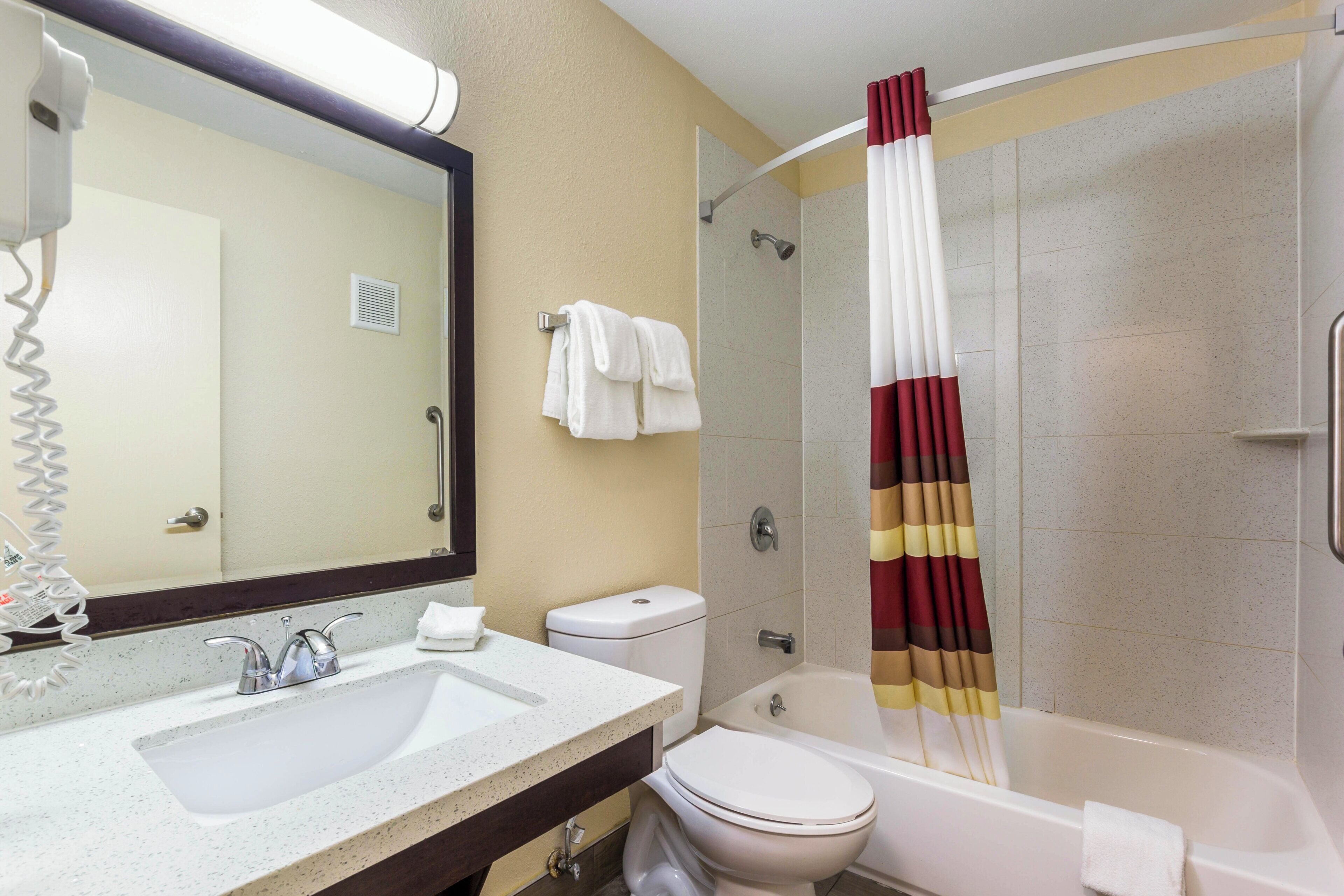 A bathroom with a sink, toilet, and bathtub.
