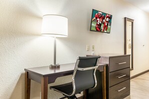 A hotel room with a desk, chair, lamp, TV, and a mirror. - Red Roof Inn Dry Ridge (Dry Ridge)