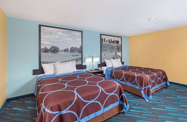 A hotel room with two beds, a nightstand, a lamp, and two framed pictures on the wall. - Super 8 by Wyndham Somerset (Somerset)