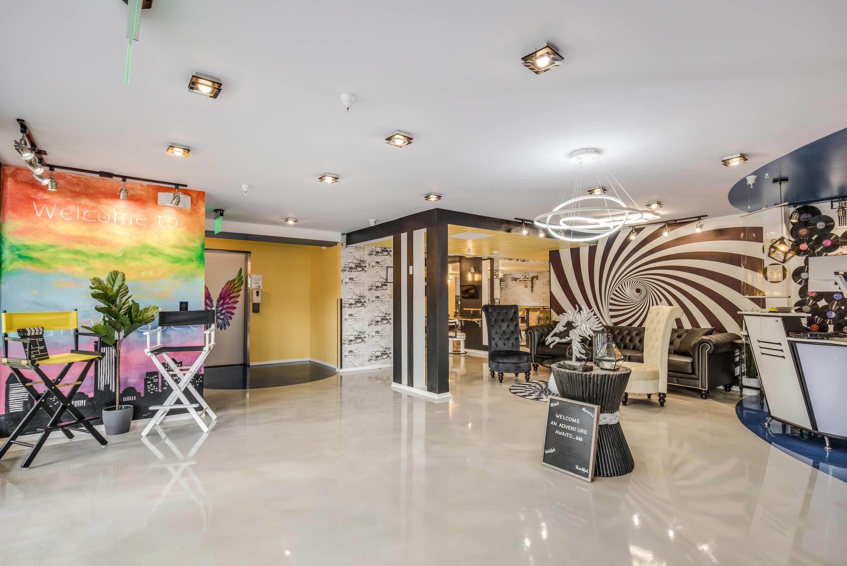 A modern interior with a welcoming banner, a unique spiral wall design, and a mix of seating areas.