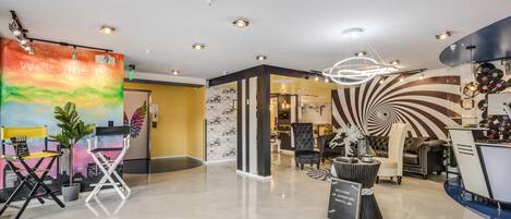 A modern interior with a welcoming banner, a unique spiral wall design, and a mix of seating areas.