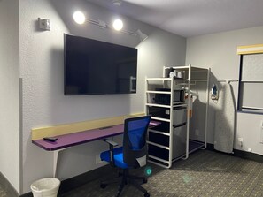 A compact room with a desk, chair, and a built-in microwave. - Clarion Pointe Tallahassee-State Capitol (Tallahassee)