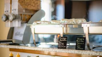 Un comptoir de cuisine avec une machine à café et un tableau affichant les différentes options de burritos, au choix avec saucisse ou légumes.